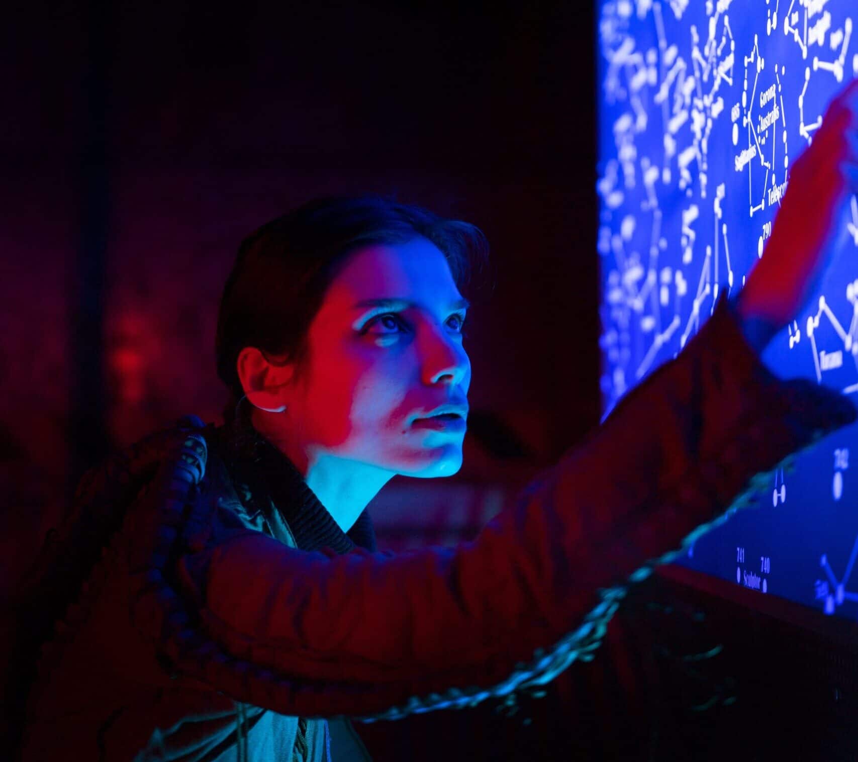 Woman looks at futuristic computer screen